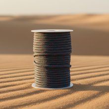טען תמונה לתצוגת גלריה, Spool of thread on a sand dune with a desert landscape in the background
